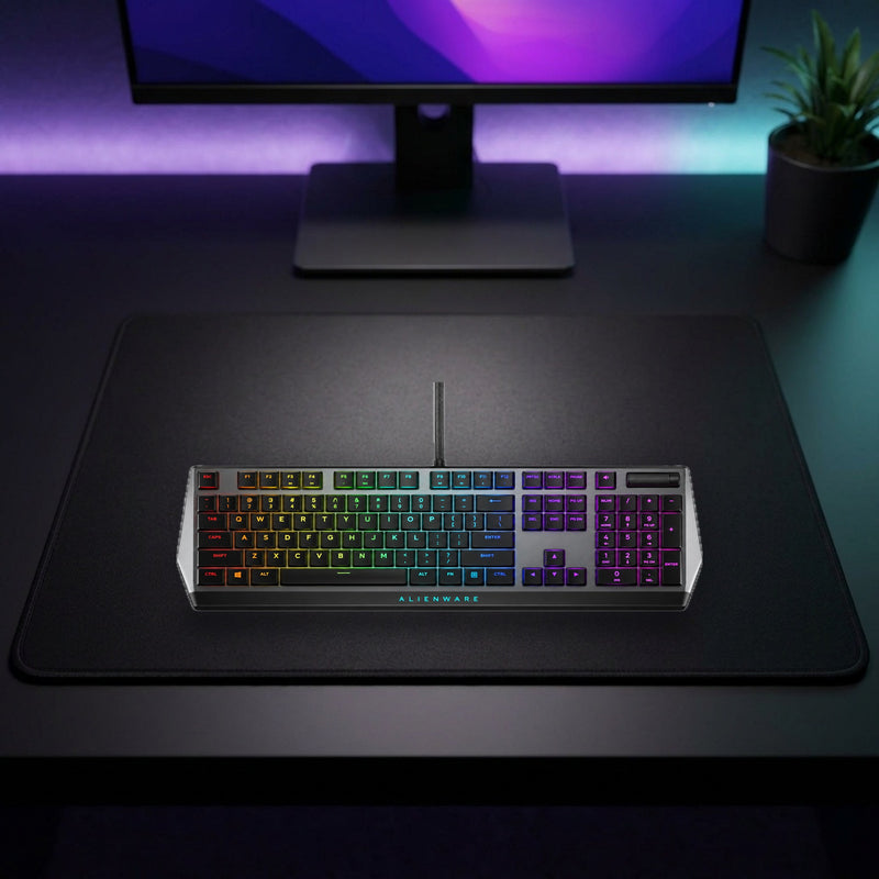 Lifestyle: Dell Alienware AW510K Low-Profile RGB Mechanical Gaming Keyboard – Cherry MX Red, US International QWERTY – Dark Side of the Moon shown on a styled desk (actual product photo, room is illustrative)