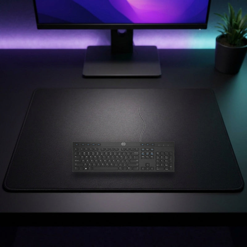 Lifestyle: Dell KB216 Wired Multimedia Keyboard – US International QWERTY – Black shown on a styled desk (actual product photo, room is illustrative)