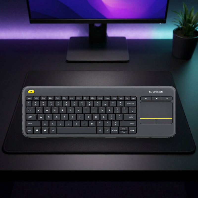 Lifestyle: Logitech K400 Plus Wireless Touch Keyboard with Built-In Touchpad and USB Unifying Receiver shown on a styled desk (actual product photo, room is illustrative)
