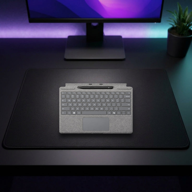 Lifestyle: Microsoft Surface Pro Signature Keyboard with Surface Slim Pen 2 – Platinum shown on a styled desk (actual product photo, room is illustrative)
