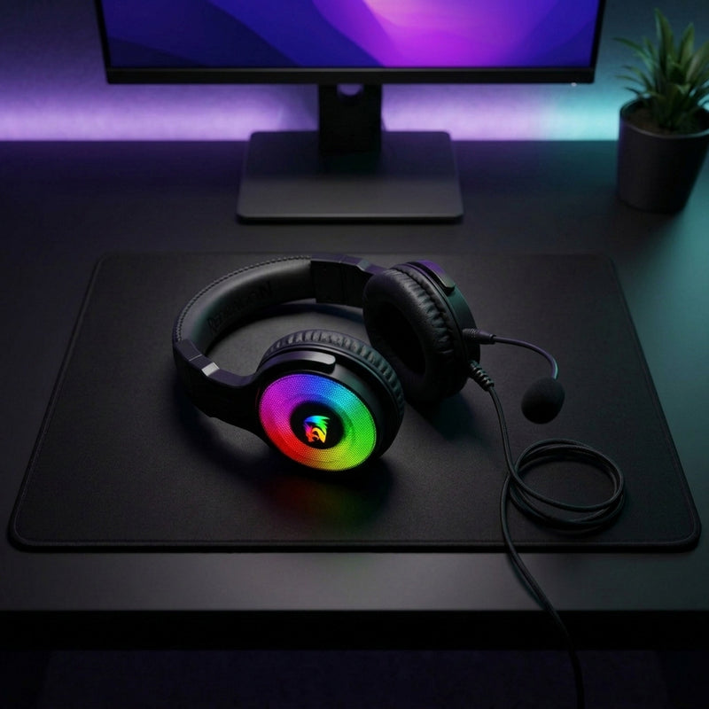 Lifestyle: Redragon H350 Pandora RGB Wired Gaming Headset | Virtual 7.1 Surround | 50mm Drivers | Detachable Mic | Black on a desk (illustrative image; the first photo shows the actual product)