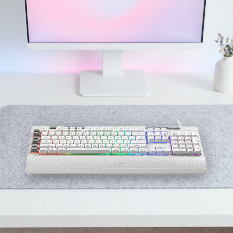 Lifestyle: Redragon K512 Shiva RGB Membrane Gaming Keyboard | Full-Size 104 Keys | 6 Macro Keys | Detachable Wrist Rest | White shown on a styled desk (actual product photo, room is illustrative)