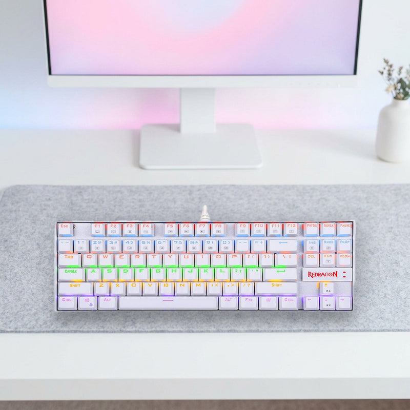 Lifestyle: Redragon K552 Kumara RGB Mechanical Gaming Keyboard | TKL 87 Keys | Red Switches | Metal Build | White shown on a styled desk (actual product photo, room is illustrative)