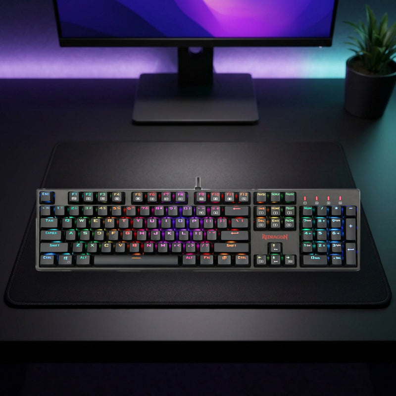 Lifestyle: Redragon K582 Surara RGB Mechanical Gaming Keyboard | Full-Size 104 Keys | Red Switches | Black shown on a styled desk (actual product photo, room is illustrative)