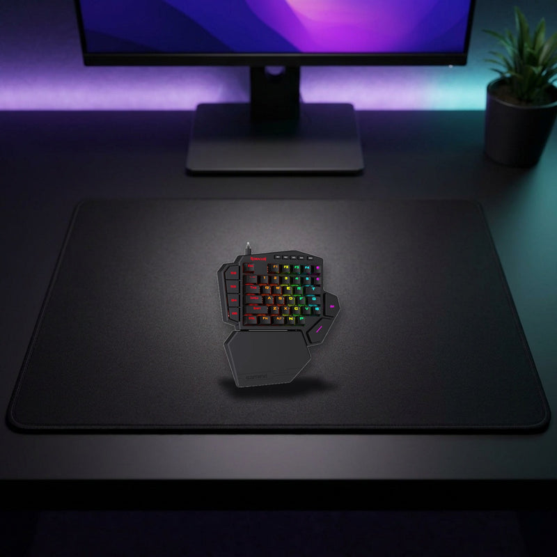 Lifestyle: Redragon K585 Pro Diti Elite One-Handed RGB Wireless Mechanical Gaming Keyboard | 42 Keys | Blue Switches | 7 Macro Keys | Black shown on a styled desk (actual product photo, room is illustrative)