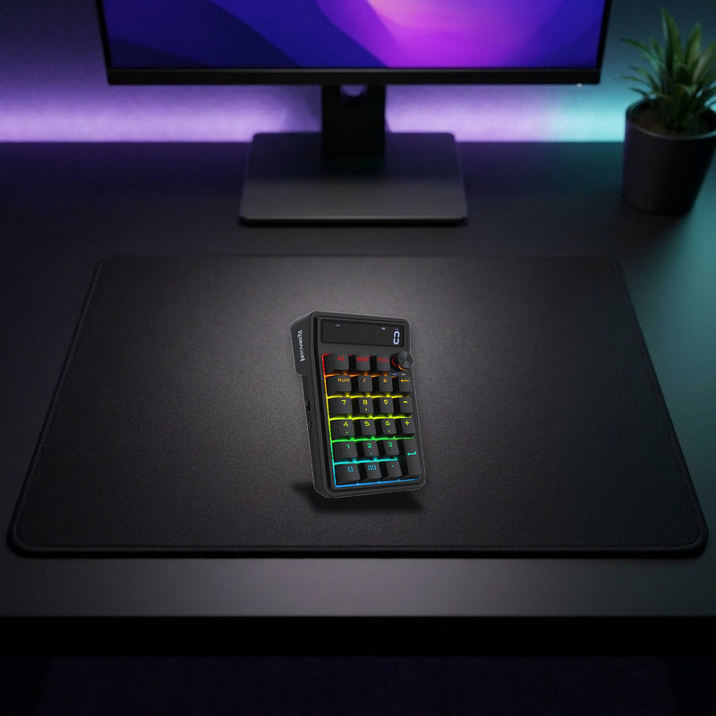 Lifestyle: Redragon K733 Cove RGB Wireless Mechanical Numpad | Calculator Display | Tri-Mode | Gasket Mount | 22 Keys shown on a styled desk (actual product photo, room is illustrative)